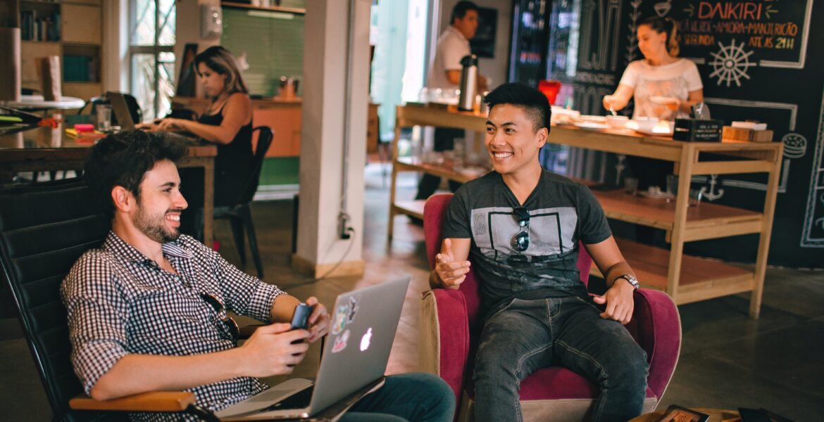 Photograph of Men Having Conversation Seating on Chair